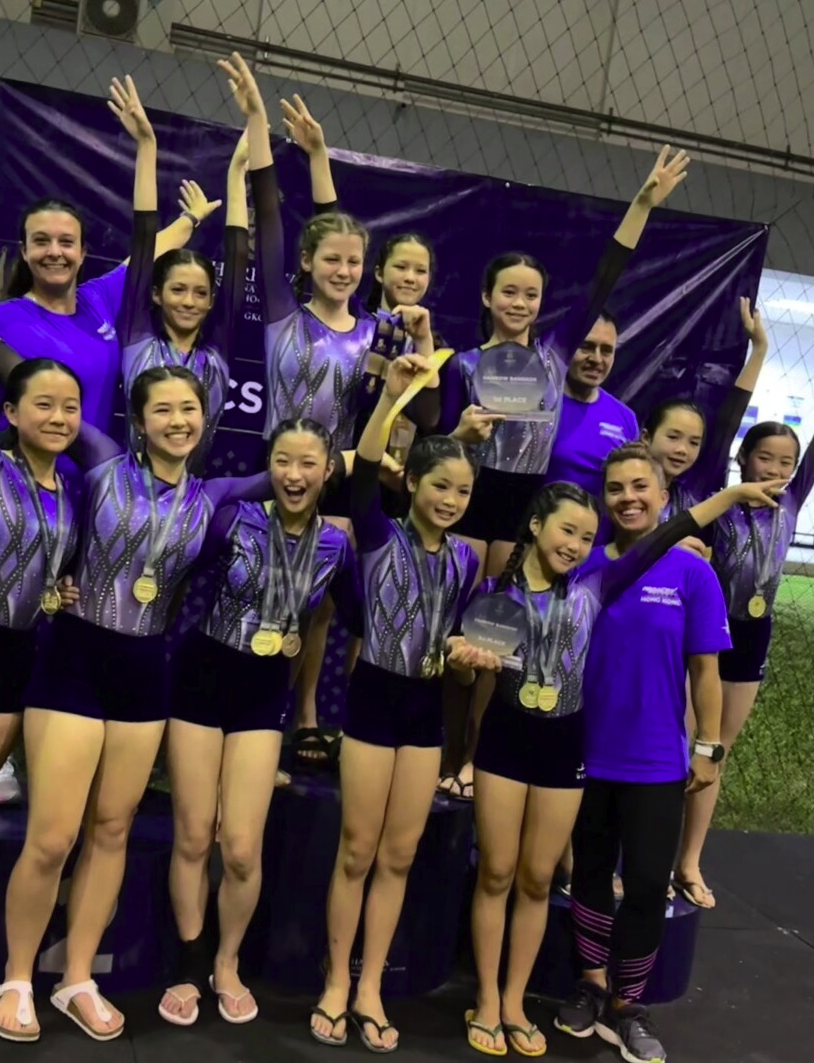 ProActiv Sports competitive gymnastics team celebrating with medals